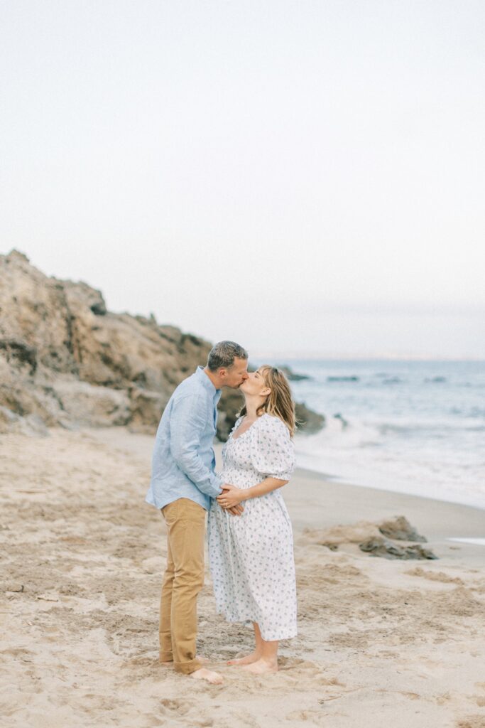 Ventura County maternity photos at the beach during golden hour, pregnant mother in flowing neutral dress at Oxnard Beach Park, coastal maternity photography inspiration in Southern California, what to wear for maternity photos in Ventura County, luxury maternity session near Ojai and Ventura beaches, romantic pregnancy photos with soft natural light, California maternity photographer capturing emotional motherhood moments outdoors, ventura county maternity, ventura county maternity photographer