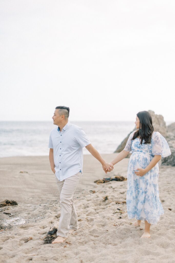 Ventura County maternity photos at the beach during golden hour, pregnant mother in flowing neutral dress at Oxnard Beach Park, coastal maternity photography inspiration in Southern California, what to wear for maternity photos in Ventura County, luxury maternity session near Ojai and Ventura beaches, romantic pregnancy photos with soft natural light, California maternity photographer capturing emotional motherhood moments outdoors, ventura county maternity, ventura county maternity photographer