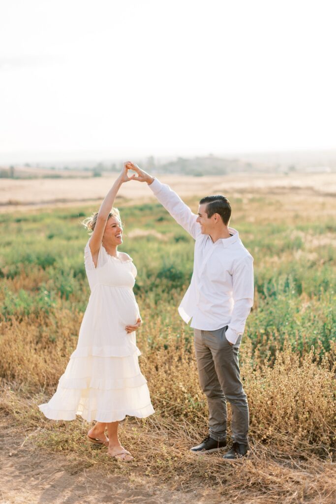 Ventura County maternity photos at the beach during golden hour, pregnant mother in flowing neutral dress at Oxnard Beach Park, coastal maternity photography inspiration in Southern California, what to wear for maternity photos in Ventura County, luxury maternity session near Ojai and Ventura beaches, romantic pregnancy photos with soft natural light, California maternity photographer capturing emotional motherhood moments outdoors, ventura county maternity, ventura county maternity photographer