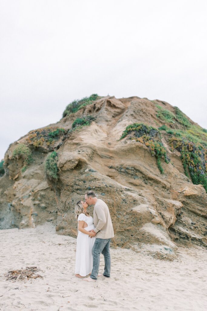 Ventura County maternity photos at the beach during golden hour, pregnant mother in flowing neutral dress at Oxnard Beach Park, coastal maternity photography inspiration in Southern California, what to wear for maternity photos in Ventura County, luxury maternity session near Ojai and Ventura beaches, romantic pregnancy photos with soft natural light, California maternity photographer capturing emotional motherhood moments outdoors, ventura county maternity, ventura county maternity photographer