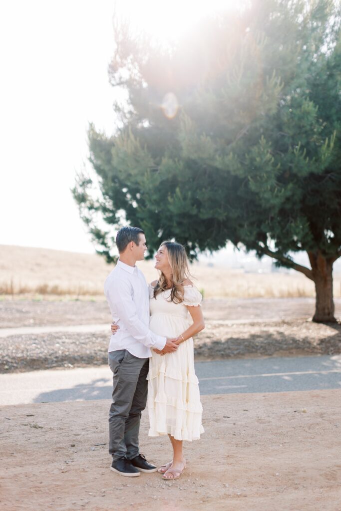 Ventura County maternity photos at the beach during golden hour, pregnant mother in flowing neutral dress at Oxnard Beach Park, coastal maternity photography inspiration in Southern California, what to wear for maternity photos in Ventura County, luxury maternity session near Ojai and Ventura beaches, romantic pregnancy photos with soft natural light, California maternity photographer capturing emotional motherhood moments outdoors, ventura county maternity, ventura county maternity photographer