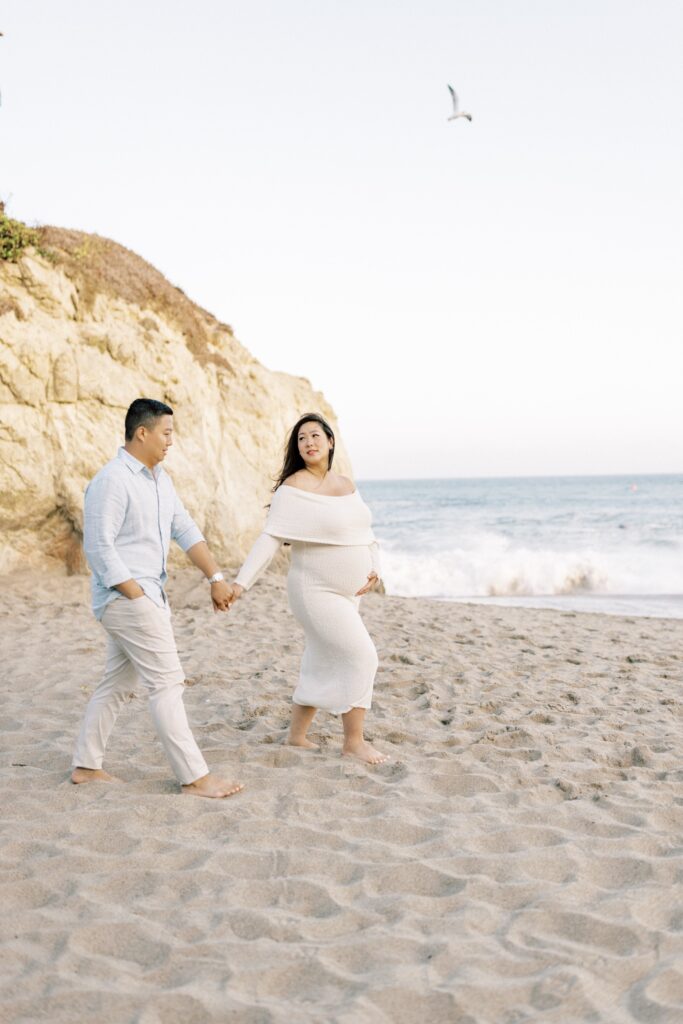 Ventura County maternity photos at the beach during golden hour, pregnant mother in flowing neutral dress at Oxnard Beach Park, coastal maternity photography inspiration in Southern California, what to wear for maternity photos in Ventura County, luxury maternity session near Ojai and Ventura beaches, romantic pregnancy photos with soft natural light, California maternity photographer capturing emotional motherhood moments outdoors, ventura county maternity, ventura county maternity photographer
