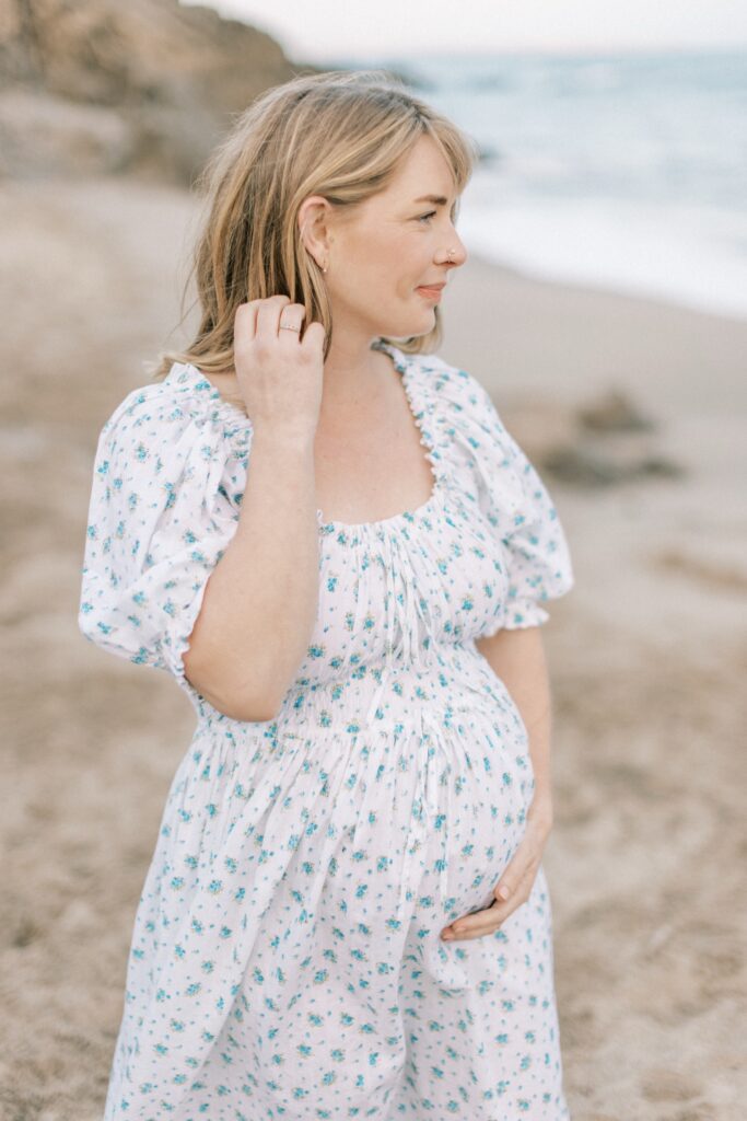 Ventura County maternity photos at the beach during golden hour, pregnant mother in flowing neutral dress at Oxnard Beach Park, coastal maternity photography inspiration in Southern California, what to wear for maternity photos in Ventura County, luxury maternity session near Ojai and Ventura beaches, romantic pregnancy photos with soft natural light, California maternity photographer capturing emotional motherhood moments outdoors, ventura county maternity, ventura county maternity photographer