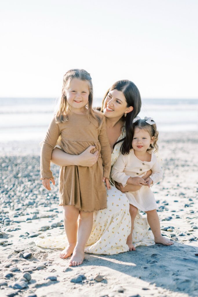 Family of four smiling together during fall family photos in Ventura County, holiday photos of kids together with christmas tree Thousand Oaks, candid shots of family fall photos, santa holiday mini sessions, fall candid mini sessions ventura county, christmas tree family session in ventura county, fall beach photos of family together in Los Angeles, beach photos of kids in fall San Diego, gingerbread making holiday photos in Thousand Oaks, holiday mini session photos in Los Angeles