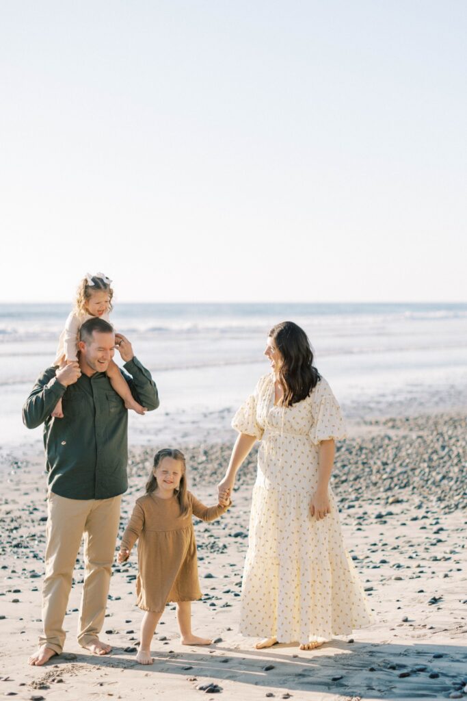 Family of four smiling together during fall family photos in Ventura County, holiday photos of kids together with christmas tree Thousand Oaks, candid shots of family fall photos, santa holiday mini sessions, fall candid mini sessions ventura county, christmas tree family session in ventura county, fall beach photos of family together in Los Angeles, beach photos of kids in fall San Diego, gingerbread making holiday photos in Thousand Oaks, holiday mini session photos in Los Angeles
