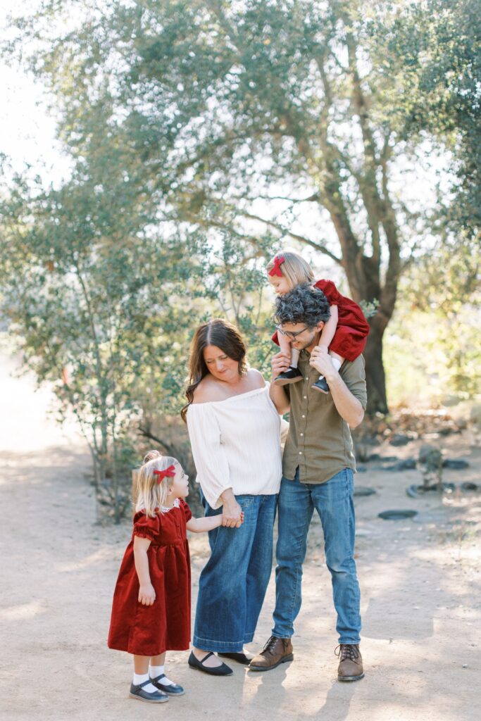 Family of four smiling together during fall family photos in Orange County, holiday photos of kids together with christmas tree Thousand Oaks, candid shots of family fall photos, Moorpark fall family photos at the beach, fall candid mini sessions ventura county, Los Angeles children with santa photos, fall beach photos of family together in Los Angeles, Orange County candid family of four photos, gingerbread making holiday photos in Thousand Oaks, holiday mini session photos in Los Angeles