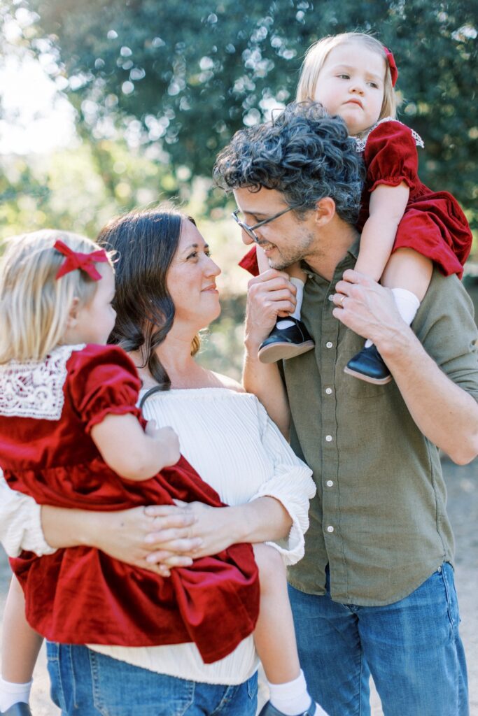 Family of four smiling together during fall family photos in Orange County, holiday photos of kids together with christmas tree Thousand Oaks, candid shots of family fall photos, Moorpark fall family photos at the beach, fall candid mini sessions ventura county, Los Angeles children with santa photos, fall beach photos of family together in Los Angeles, Orange County candid family of four photos, gingerbread making holiday photos in Thousand Oaks, holiday mini session photos in Los Angeles