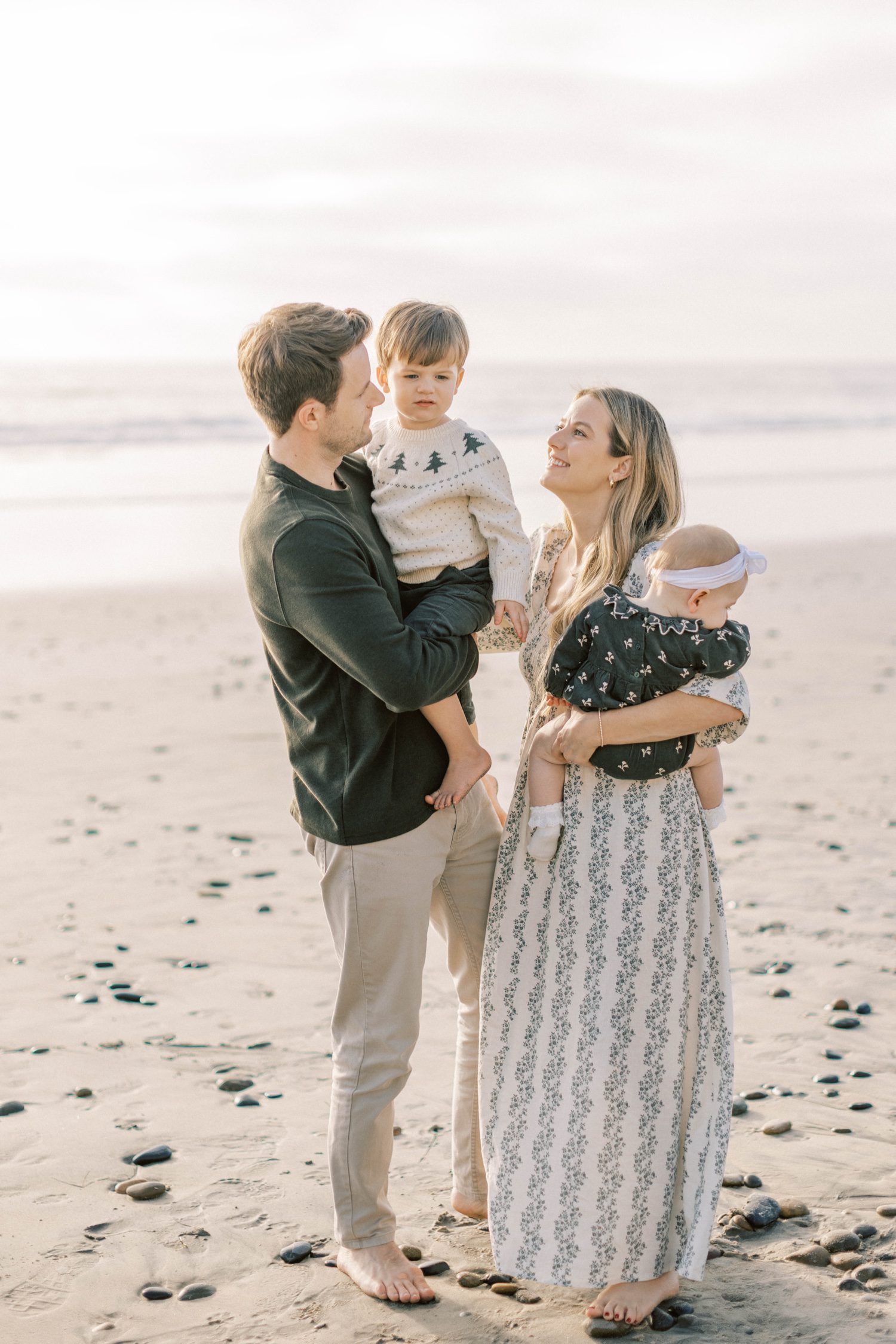 Family of four smiling together during fall family photos in Ventura County, family group shot in ventura county for fall family photos, candid shots of family fall photos, santa holiday mini sessions, holiday mini sessions ventura county, christmas tree family session in ventura county, Ventura County family photos of four at the beach candid, fall beach photos of family together in San Diego, fall beach photos of family together in Orange County, holiday mini session photos in Los Angeles